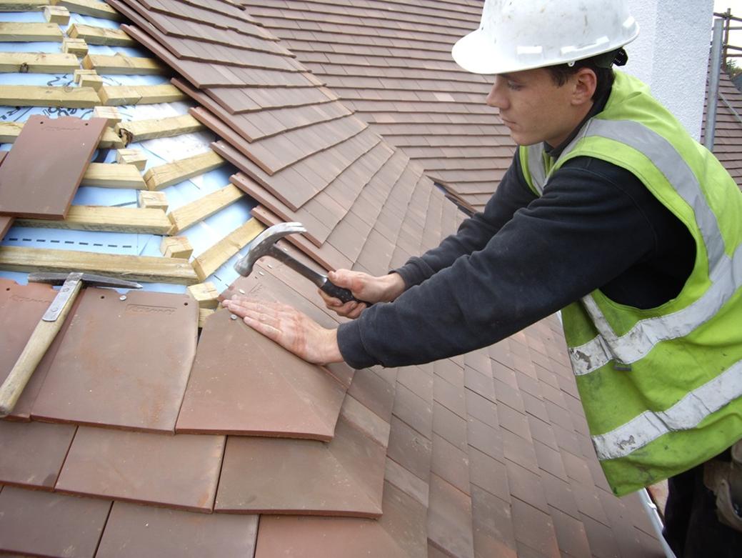 Roofing-Repair-Contractors-In-Action-On-top-Of-Roof